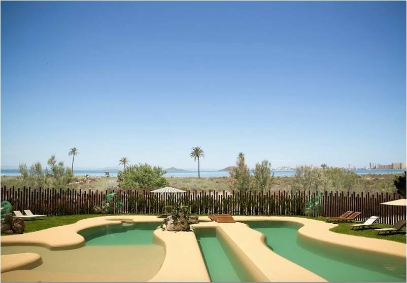 The sand swimming pool, a pool like no other, designed to blend into the background of the beach, an oasis of Mediterranean plants and grasses in perfectly in tune with its surroundings.